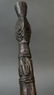 This dark paddle handle has design/ clan motifs on the - 3