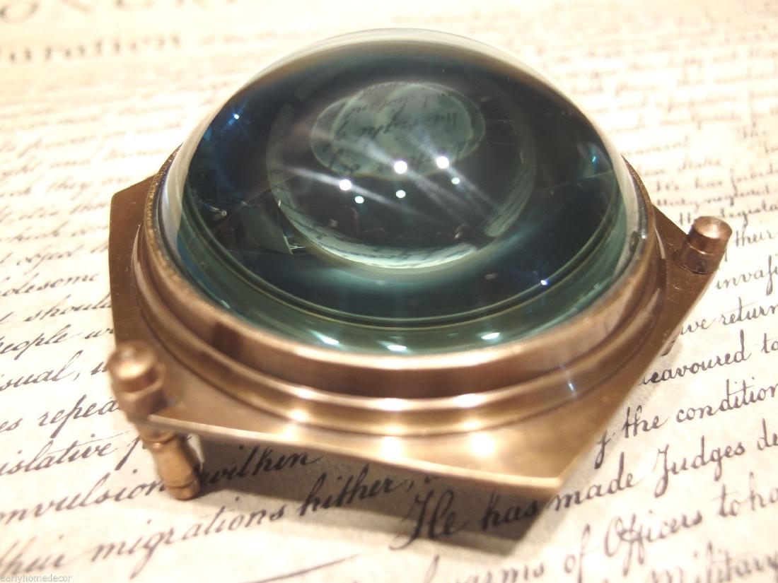 4"Solid Brass Heavy Glass Magnifying Desk Lens: 4" Wide x 2" High Nice reproduction of an antique magnifying lens. Nice heavy quality thick glass. This piece slides along the surface and magnifies quite well. Magnifying glasses like this were used 