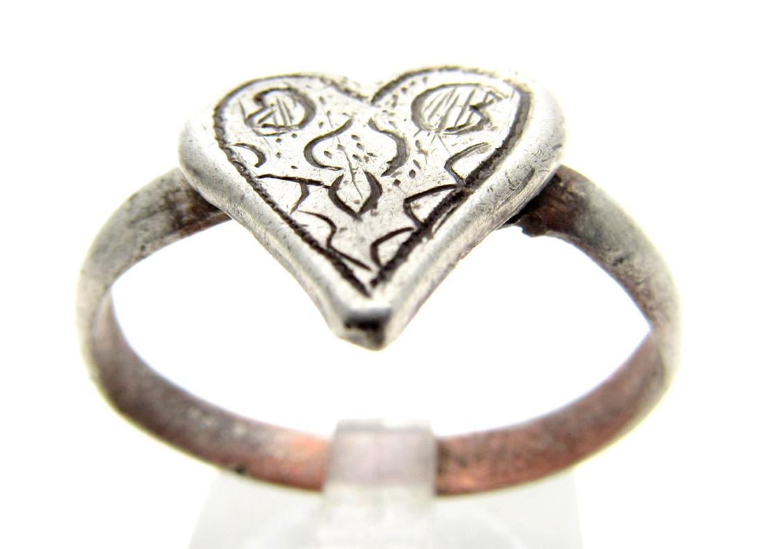 Medieval Renaissance Silver Heart Ring with Stylized: Date: Circa 16th Century Material: silver Provenance: Obtained from an old British collection; Purchased from a private London collector, acquired between 1960-1990. Dimensions: 22mm; 4.2grams Medieva
