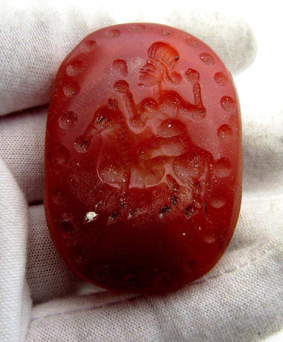 Large Persian Carnelian Intaglio Stone: Date: 18th - mid 20th C AD Provenance: Property of a London Gallery; formerly in 1980s - 1990s British collection Dimensions: 46mm; 38.1grams Large Persian Carnelian Intaglio Stone (bead) depicting a 