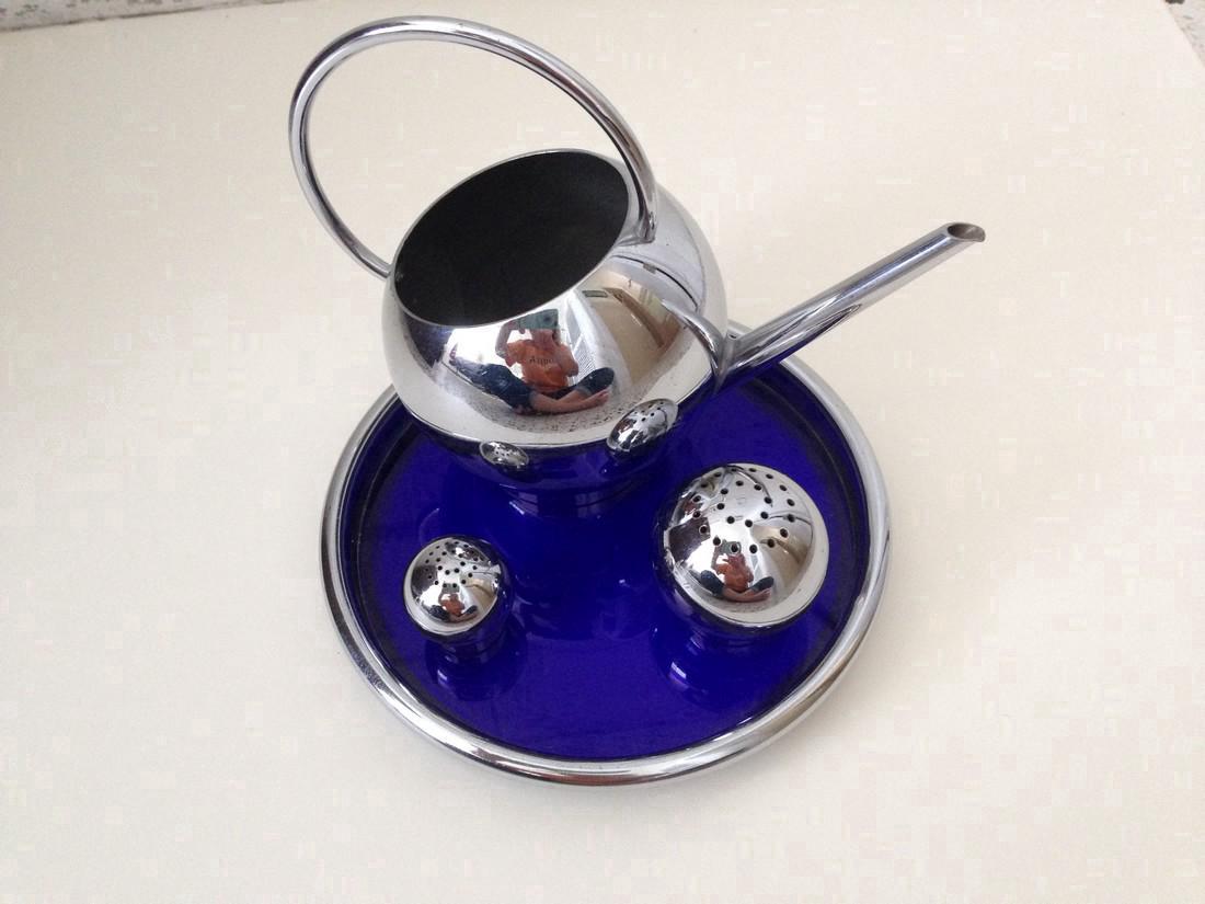 Chase 4 Piece Corn Set: Chase corn set with blue glass tray, butter pitcher, salt and pepper shakers designed by Russel Wright Please note that this lot has a confidential reserve. When you leave a bid in advance of the auct