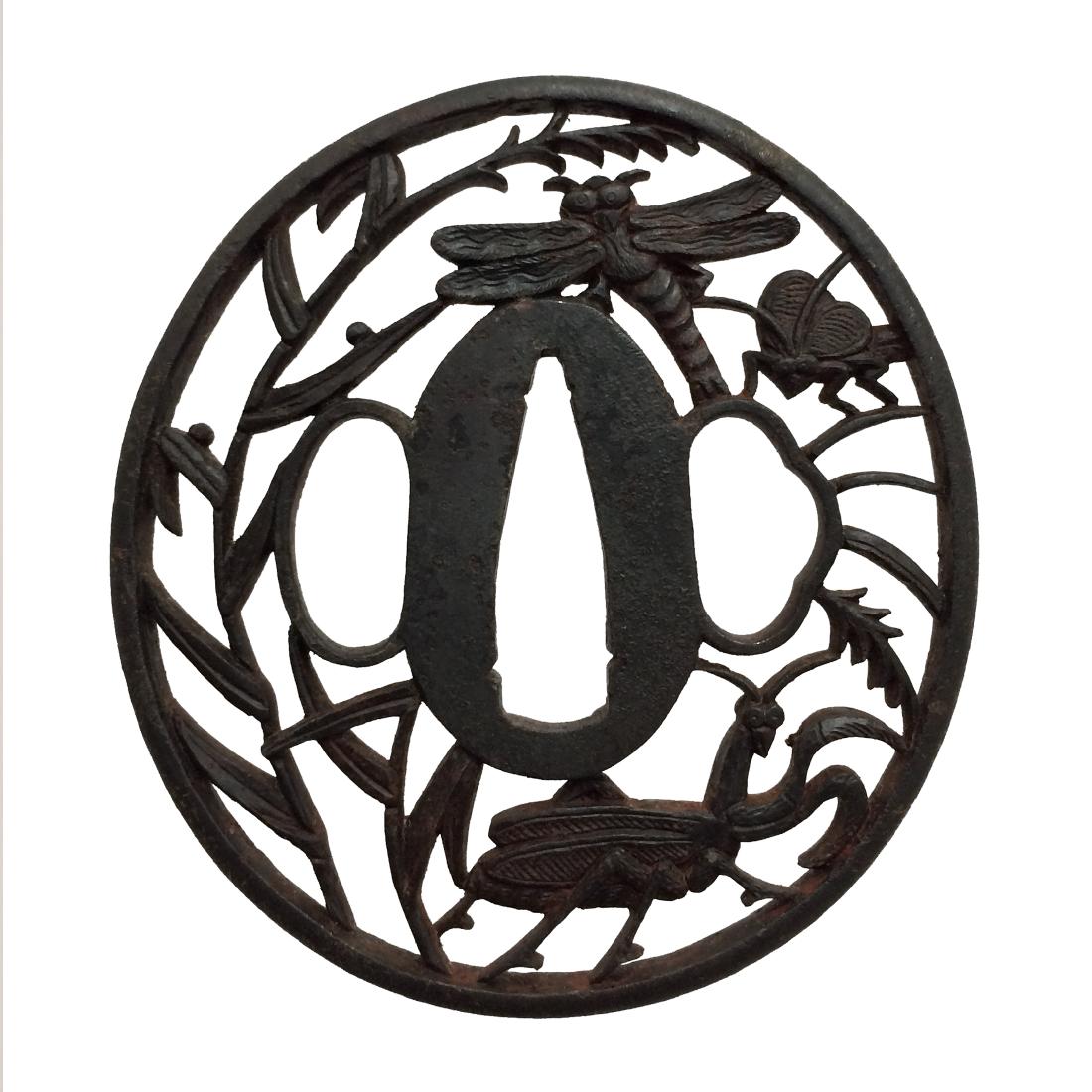 Iron sukashi tsuba: Item: Iron sukashi tsuba Origin: Japan Date: Edo period Materials: Iron Height: 72.3 mm; Width: 66.8 mm; Thickness: 4.3 mm; Weight: 61 g Iron tsuba of oval form with insects (a dragonfly, a fly, and a