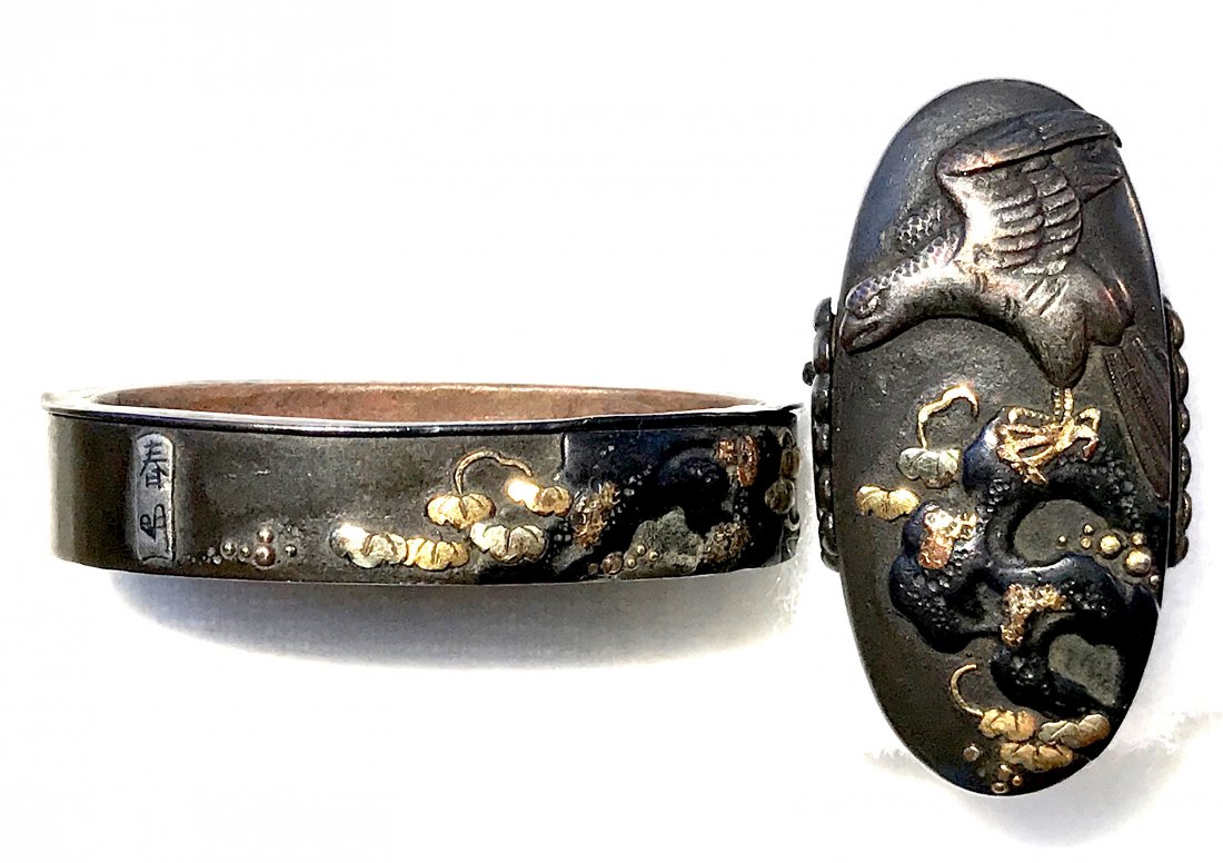 Signed Fuchi-Kashira of iron with brass, shakudo and: Item: Signed Fuchi-Kashira of iron with brass, shakudo and gold inlay by Haruaki Origin: Japan Date: Edo period Materials: Iron, brass, shakud?, gold Kashira: 34 mm; Fuchi: 38 mm Eagle on a tree branc