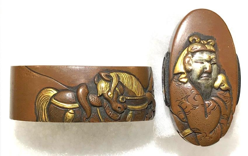 Fuchi-Kashira of brass with gold inlay: Item: Fuchi-Kashira of brass with gold inlay Origin: Japan Date: Edo period Materials: Brass, gold Kashira: 34.5 mm; Fuchi: 39 mm A warrior on the kashira and a horse on the fuchi. Unsigned. In a wood