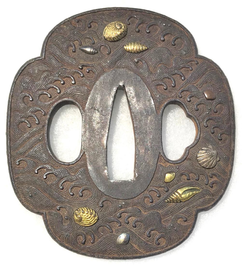Iron tsuba carved and inlaid with gold, silver, and: Item: Iron tsuba carved and inlaid with gold, silver, and copper Origin: Japan Date: Edo period Materials: Iron, gold, copper, silver Height: 76.9 mm; Width: 69.5 mm; Thickness: 5.5 mm; Weight: 144 g 