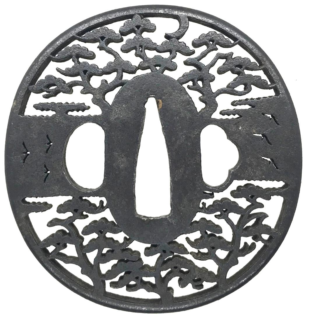 Iron sukashi tsuba with pine trees and wild geese: Item: Iron sukashi tsuba with pine trees and wild geese Origin: Japan Date: Edo period Materials: Iron Height: 72.0 mm; Width: 69.7 mm; Thickness: 5.2 mm; Weight: 95 g An iron tsuba of oval form decor