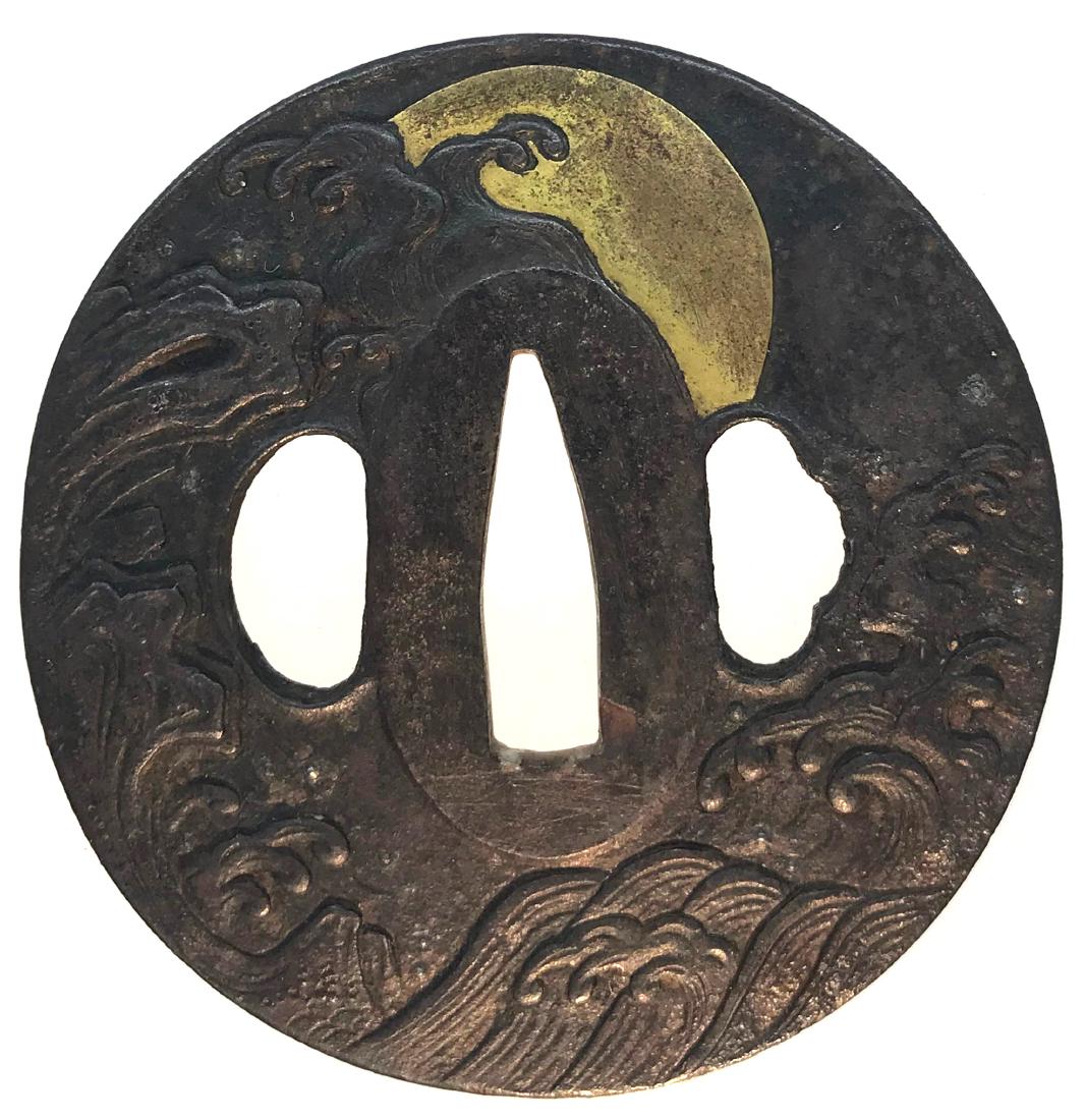 Iron tsuba carved and inlaid with gold: Item: Iron tsuba carved and inlaid with gold Origin: Japan Date: Edo period Materials: Iron, gold Height 73.9 mm; Width: 72.6 mm; Thickness: 5.4 mm; Weight: 147 g An iron tsuba of slightly elongated r
