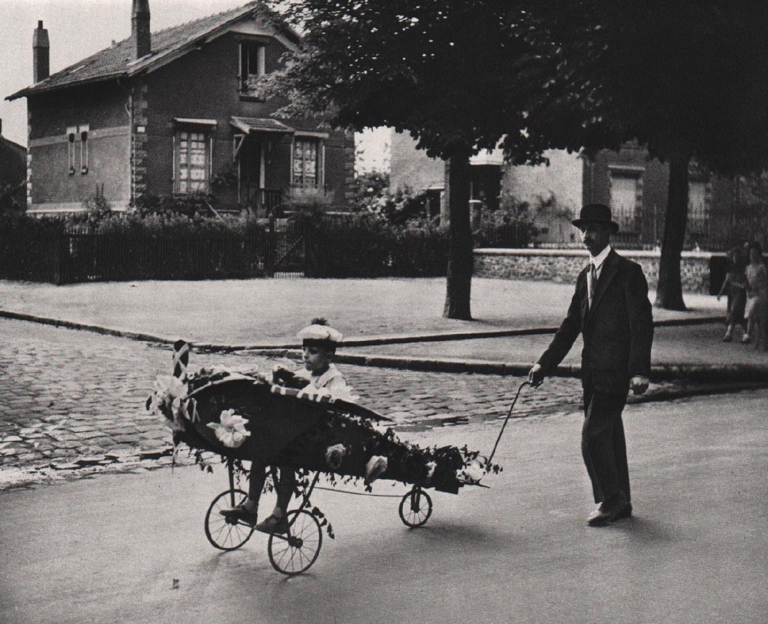 ROBERT DOISNEAU - Daddy's Plane, 1934: Artist: ROBERT DOISNEAU Print Title: Daddy's Plane, 1934 Medium: Sheet-fed Gravure Printing Date: 1979 Printing Location: France Image Size: 7 x 5.5 inches Robert Doisneau (1912-1994) was a French pho