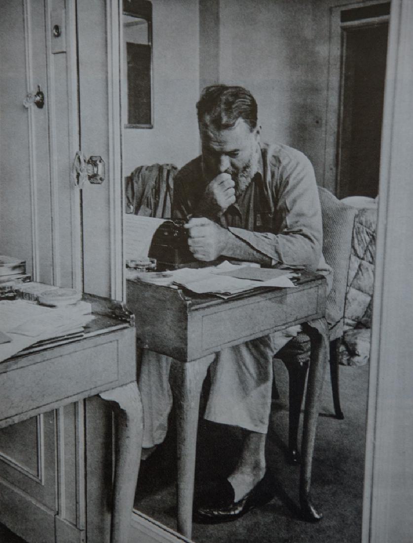 KURT HUTTON - Ernest Hemingway At Work, 1944: Artist: Kurt Hutton Title: Ernest Hemingway At Work, 1944 Medium: 1976 Sheet Fed Gravure Dimensions: 7x9.25" Wax Tissue Heat Mount on 11x14" conservation board With COA Please note that this lot has a