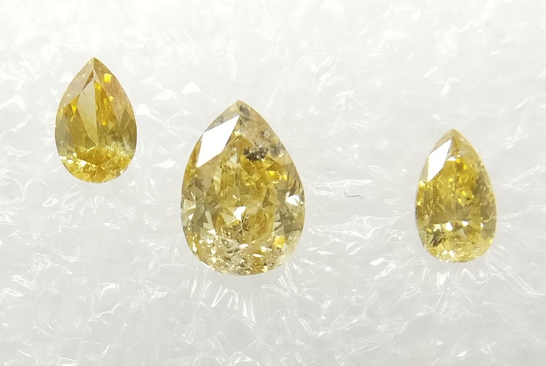 Triple of 3 Pear cut diamonds total 0.42 ct F.I. to: Item: Triple of 3 Pear cut diamonds total 0.42 ct F.I. to Vivid Brownish Yellow SI-I1Shape: Pear Color: F.I. to Vivid Brownish Yellow SI-I1 Carat Weight: 0.42 Size/Dimensions: G/VG-G-N/F Sealed Please