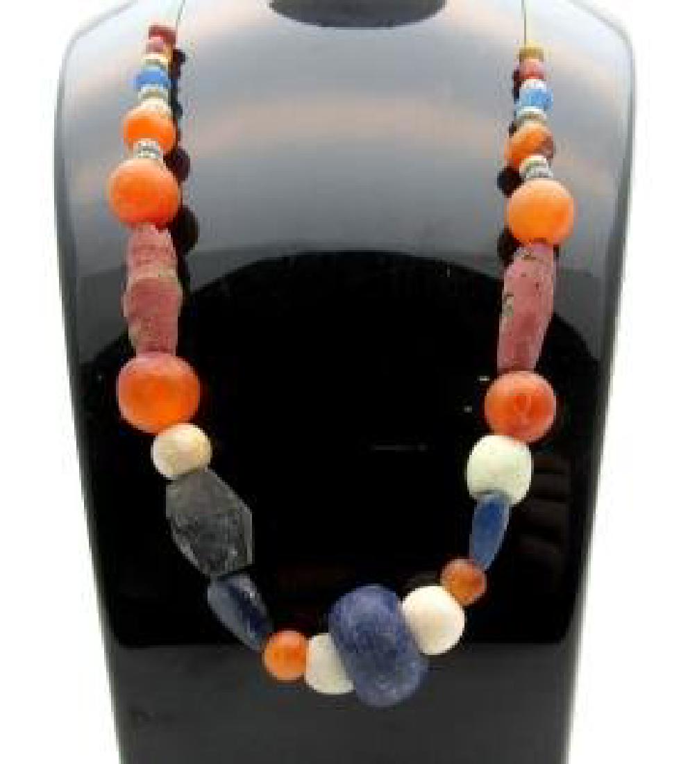Medieval Viking glass and carnelian beaded necklace: Date: CA.900 1100 AD Material: glass Provenance: Obtained from an old British collection, acquired from B.C.F. (Birmingham). Dimensions: 260mm; 30 grams Medieval Viking glass and carnelian beaded neck