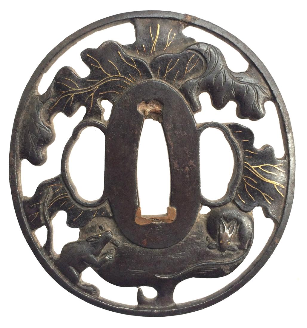 Iron tsuba, pierced, carved and inlaid with gold: Item: Iron tsuba, pierced, carved and inlaid with gold Origin: Japan Date: Edo period Materials: Iron, gold Height: 72.9 mm; Width: 67.9 mm; Thickness: 4.6 mm; Weight: 90 g Slightly elongated round ir