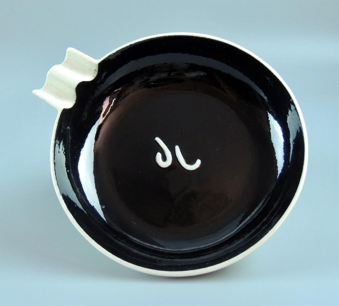 Ca.1957 Rookwood Ashtray: Circa 1957 Rookwood Gloss Glaze Ashtry in black and white with letters appear to be “JC” or “JL”. Impressed Rookwood mark and date (XLVII) 1957 Size: 1” high x 5.75” widest Please note tha