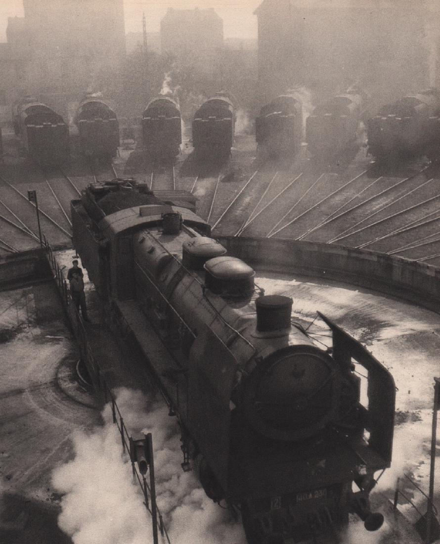 ROBERT DOISNEAU - Train Depot: Artist: ROBERT DOISNEAU Print Title: Train Depot Medium: Sheet-fed Gravure Printing Date: 1949 Printed in Switzerland Image Size: 6.5 x 7.5 inches Robert Doisneau (1912-1994) was a French photographer