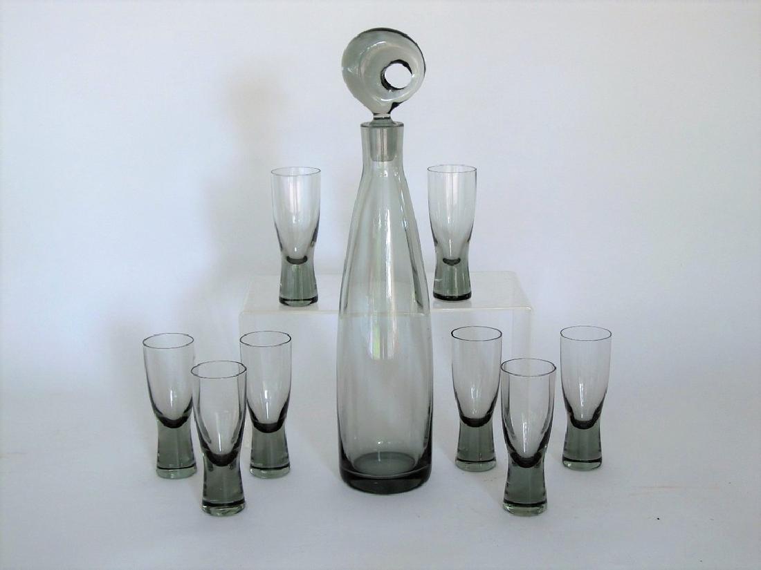 Holmegaard Aristokrat Glass Decanter Set w/ 8 Cordials: Title: Holmegaard "Aristokrat" Decanter Set w/ 8 "Canada" Cordial Glasses Maker: Holmegaard Origin: Denmark Date/Period: 1960s Materials: Glass Size: 14.5" x 3" Iconic mid century organic design by Ho
