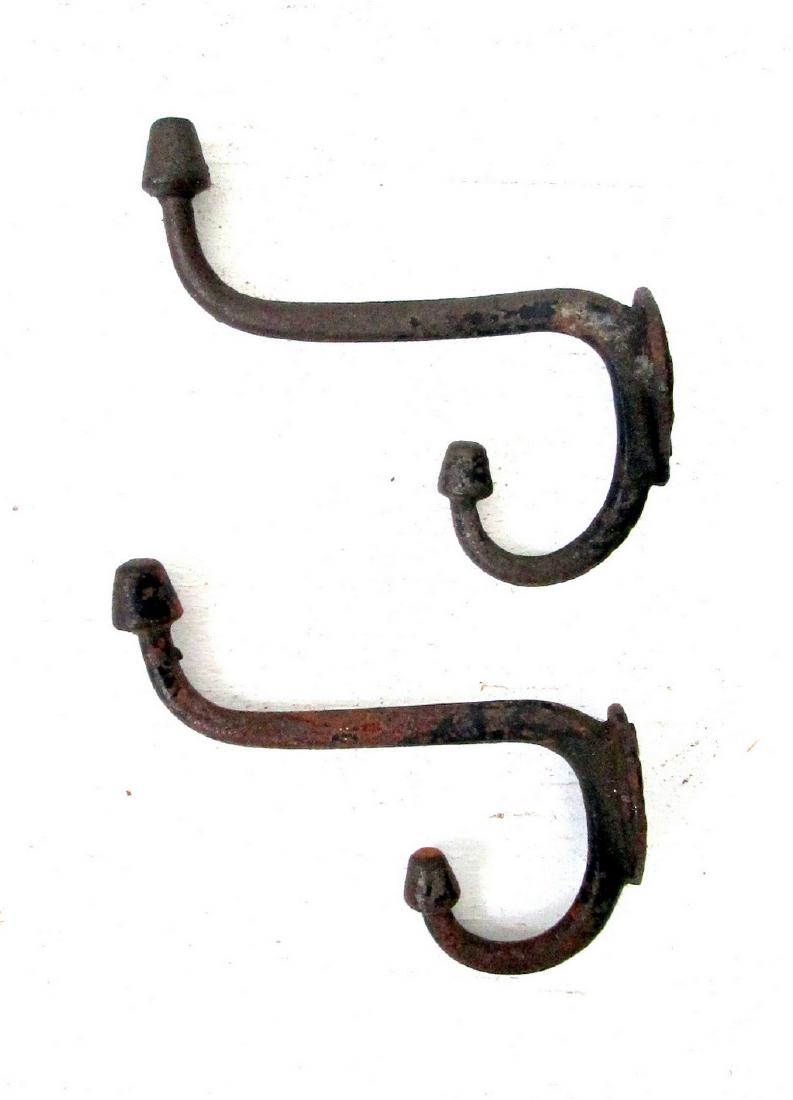 Early Acorn Motif Coat Hooks: Early Acorn Motif Coat Hooks Late 19th Century Cast Iron 3 3/4"H X 1"W X 3 1/2"D Double acorn ended, teardrop backplate, dry worn original black painted surfaces, lightly oxidized. Please note that th
