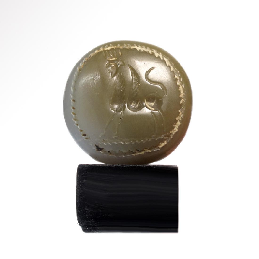 Large Assyrian Chalcedony Sphinx Seal, C. 600 BC: Large Assyrian Chalcedony Sphinx Seal, c. 600 B.C. Assyrian, c. 600 B.C. Highly polished blue-grey chalcedony of dome shape, engraved with a winged Sphinx with king’s head wearing a crown. Rope patt