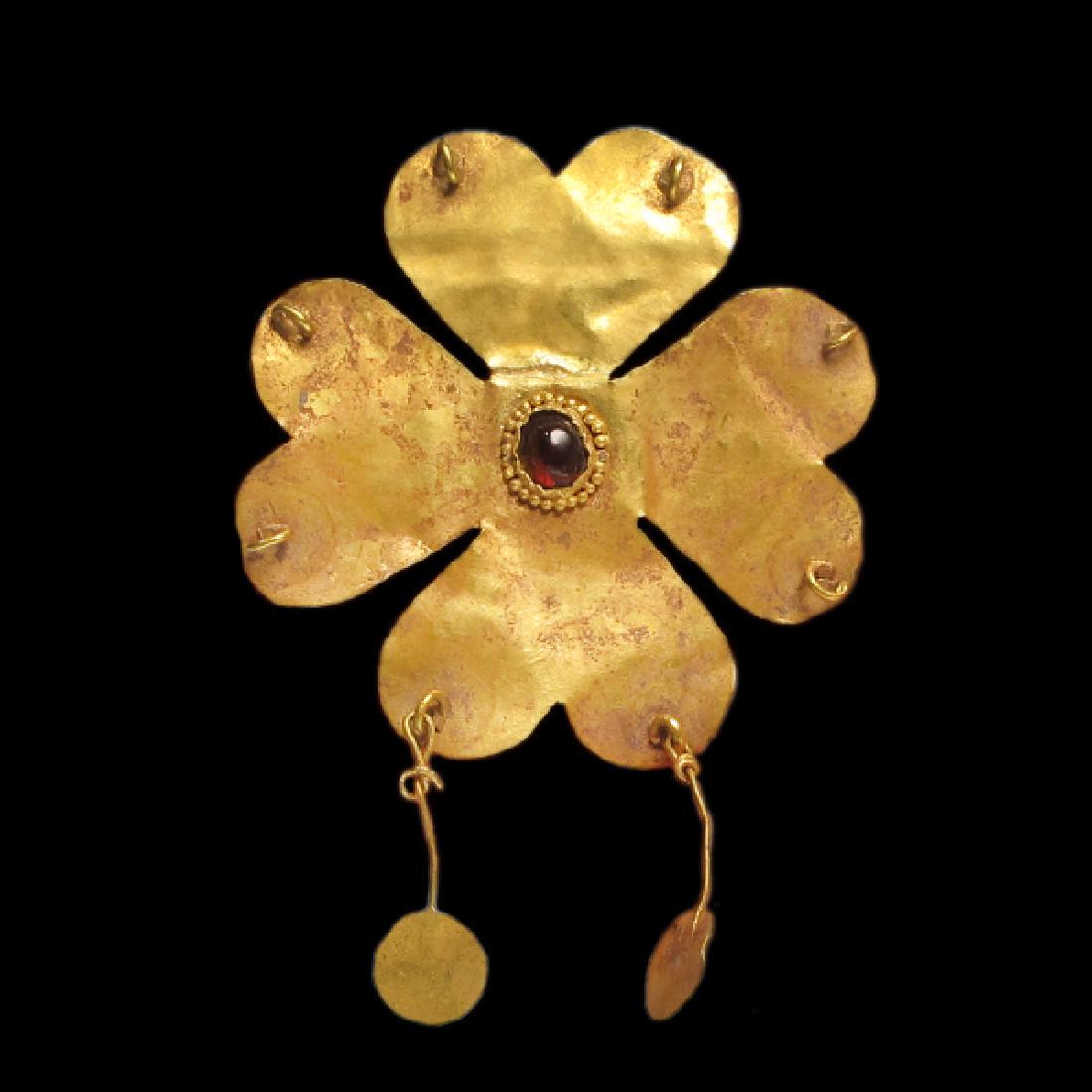 Greek Gold Diadem Central Attachment, 1st Millennium BC: Greek Gold Diadem Central Attachment, c. 1st Millennium B.C. Greek, c. 1st Millennium B.C. Gold sheet rosette with four double leaves, each with a loop for pendants, round central bezel inserted with 