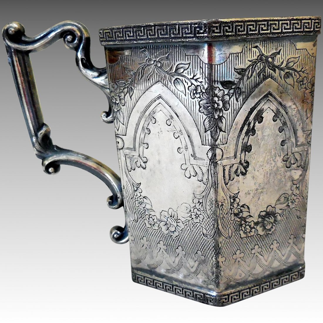 Gothic Revival Silver Plated Can/Cup: Title: Gothic Revival Silver Plated Can/Cup Maker: Reed & Barton Origin: USA Date/Period: 1840-1860 Materials: Silver on white metal Size: 3 1/4 Inches tall, 2 7/8 Inches wide (not including handle) T