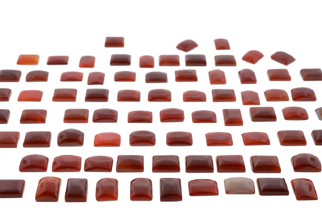 Lot: CARNELIAN 1000 cts 50st: Weight: 1000cts. Stone Count: 50 Average Weight Per Stone: 19.61 Shape(s): Rectangle Approximate Size/Size Range 20x15 mm Color: RED ORANGE Clarity Range: Translucent Please note that this lot has a c