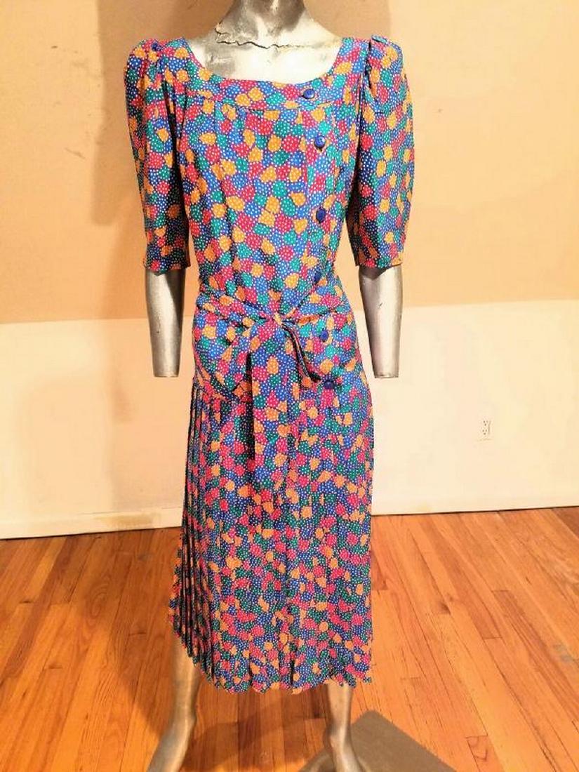 Vintage Givenchy Paris Nouvelle Boutique silk wiggle: A beautiful Givenchy Paris Nouvelle Boutique dress. Colorful design, low waist with pleated skirt and sash belt. Side bodice buttons. In amazing condition.This one is a beauty from the Past 1970's. Am