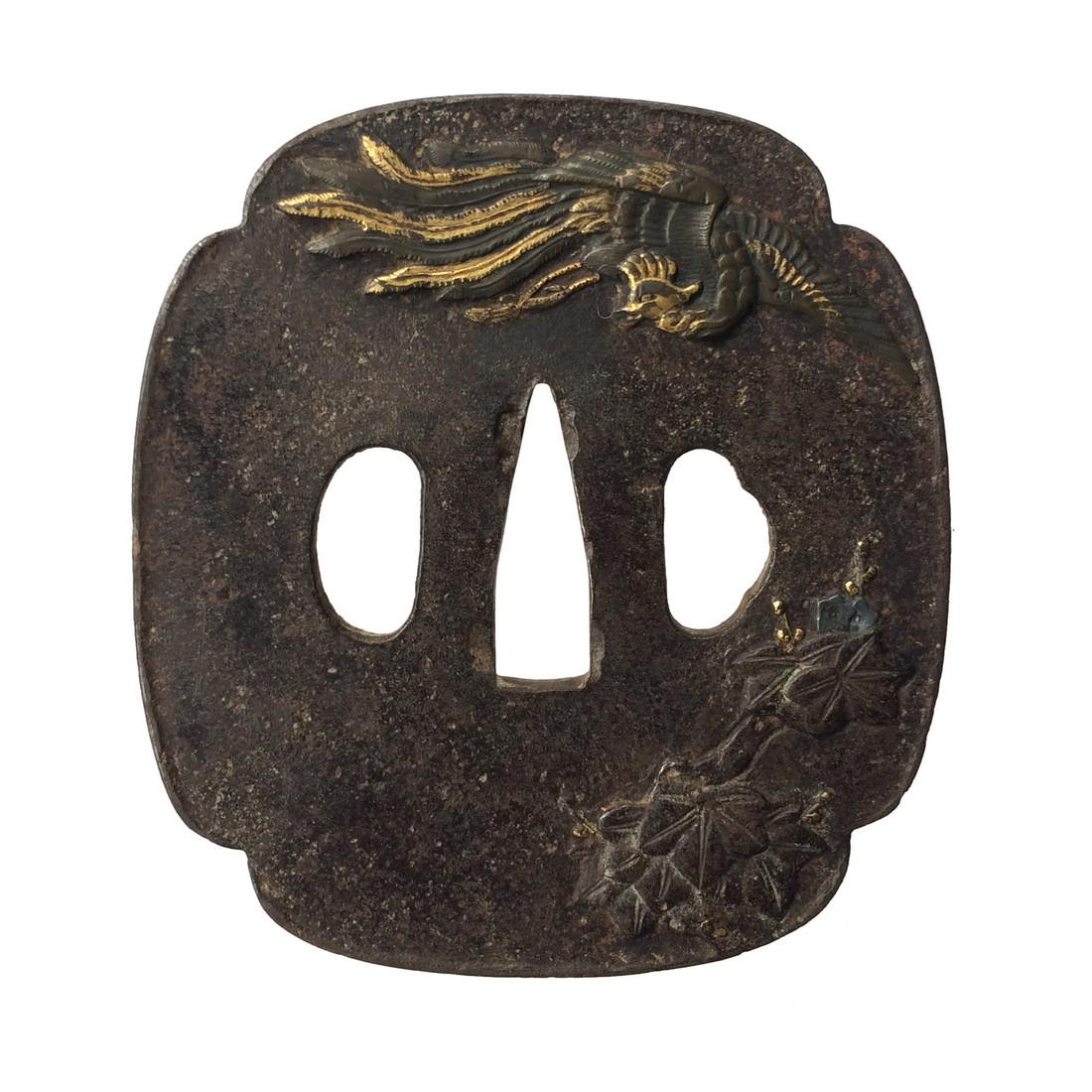 Irin tsuba with phoenix motif: Item: Irin tsuba with phoenix motif Origin: Japan Date: Edo period Materials: Iron, shakudo, gold Dimensions: 80.7 x 74.3 x 2.6 mm Iron tsuba of morro form inlaid with phoenix and paulownia leaves in 