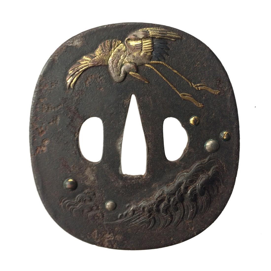 Iron tsuba with shibuichi and gold inlay: Item: Iron tsuba with shibuichi and gold inlay Origin: Japan Date: Edo period Materials: Iron, shibuichi, gold Dimensions: 86.0 x 79.5 x 3.3 mm Iron tsuba of rounded square form carved and inlaid with
