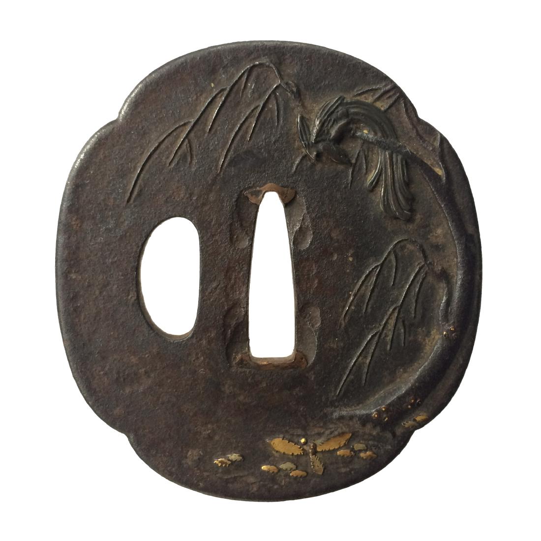 Iron tsuba with phoenix inlaid in shakudo: Item: Iron tsuba with phoenix inlaid in shakudo Origin: Japan Date: Edo period Materials: Iron, gold, shakudo Dimensions: 72.4 x 66.7 x 3.3 mm Iron tsuba of mokko form carved and inlaid with a phoenix