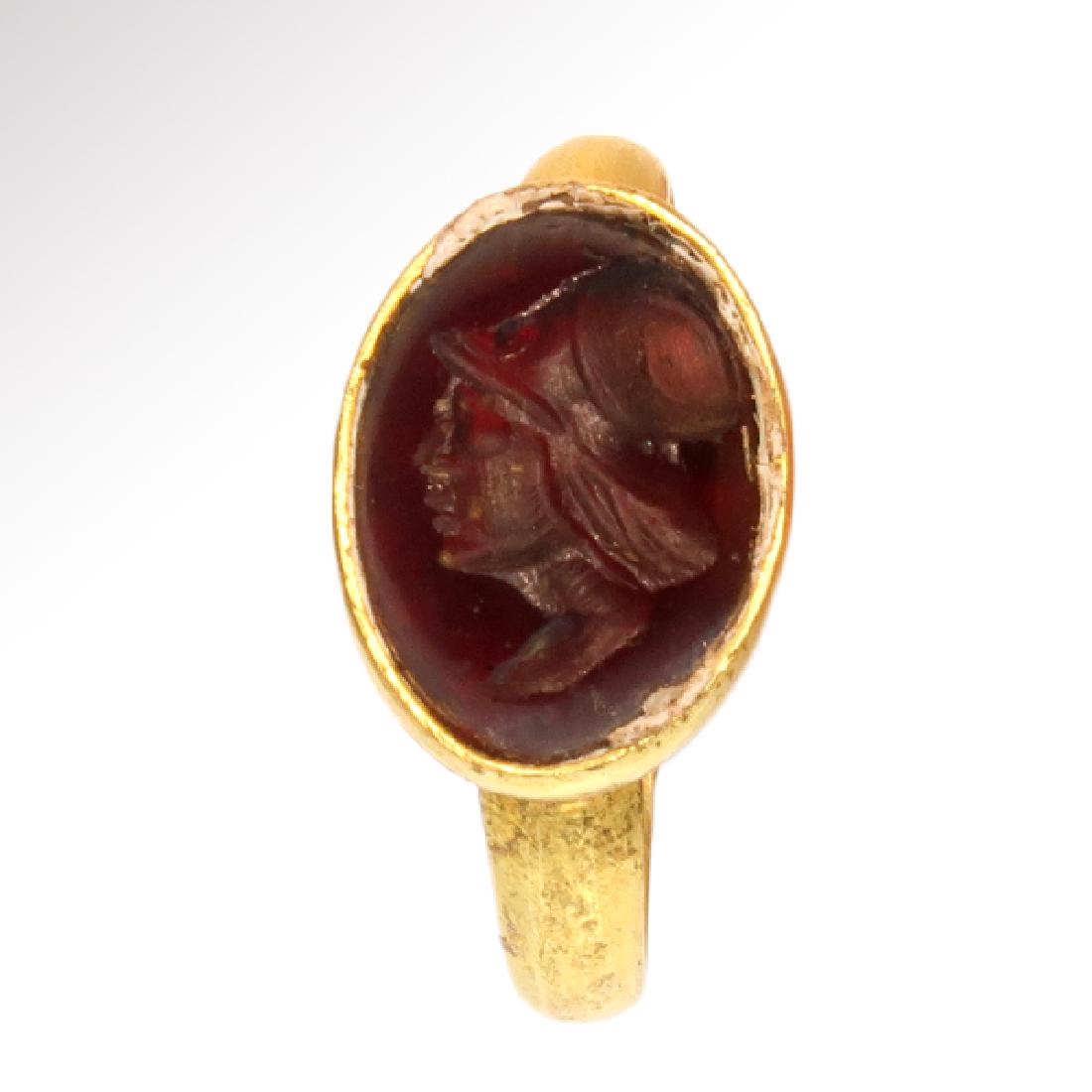 Roman Gold and Garnet Intaglio with Head of Minerva: Roman Gold and Garnet Intaglio with Head of Minerva Roman, c. 2nd Century AD The oval garnet intaglio, engraved with the head of the goddess Minerva wearing a helmet. Gold and Cornelian, 4.4 grams USA