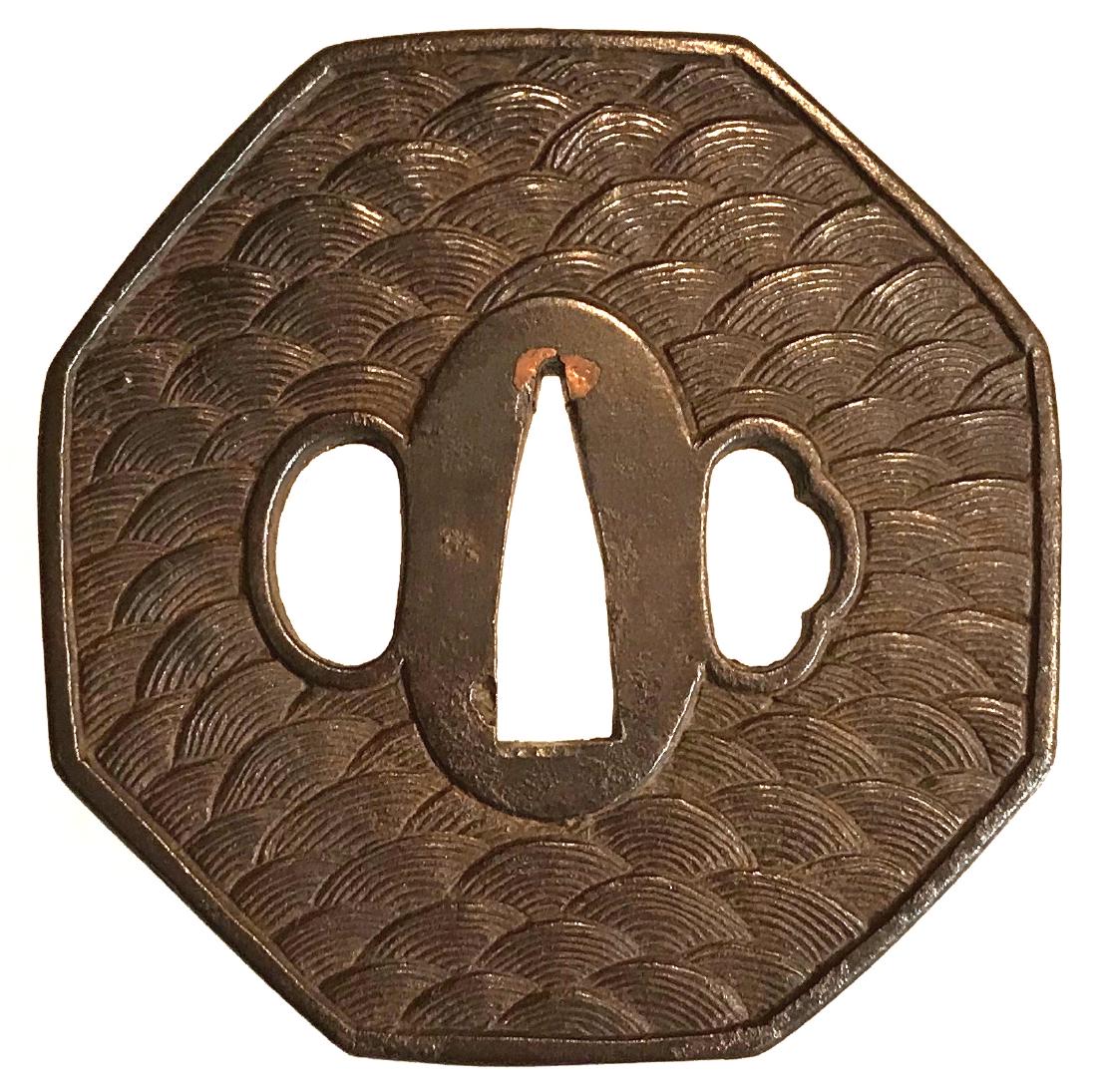 Iron hexagonal tsuba with waves motif: Item: Iron hexagonal tsuba with waves motif Origin: Japan Date: Edo Period Materials: Iron Dimensions: 81.6 x 80.6 x 6.2 mm Heavy: 209 g. Iron tsuba of hexagonal form carved in relief with waves motif