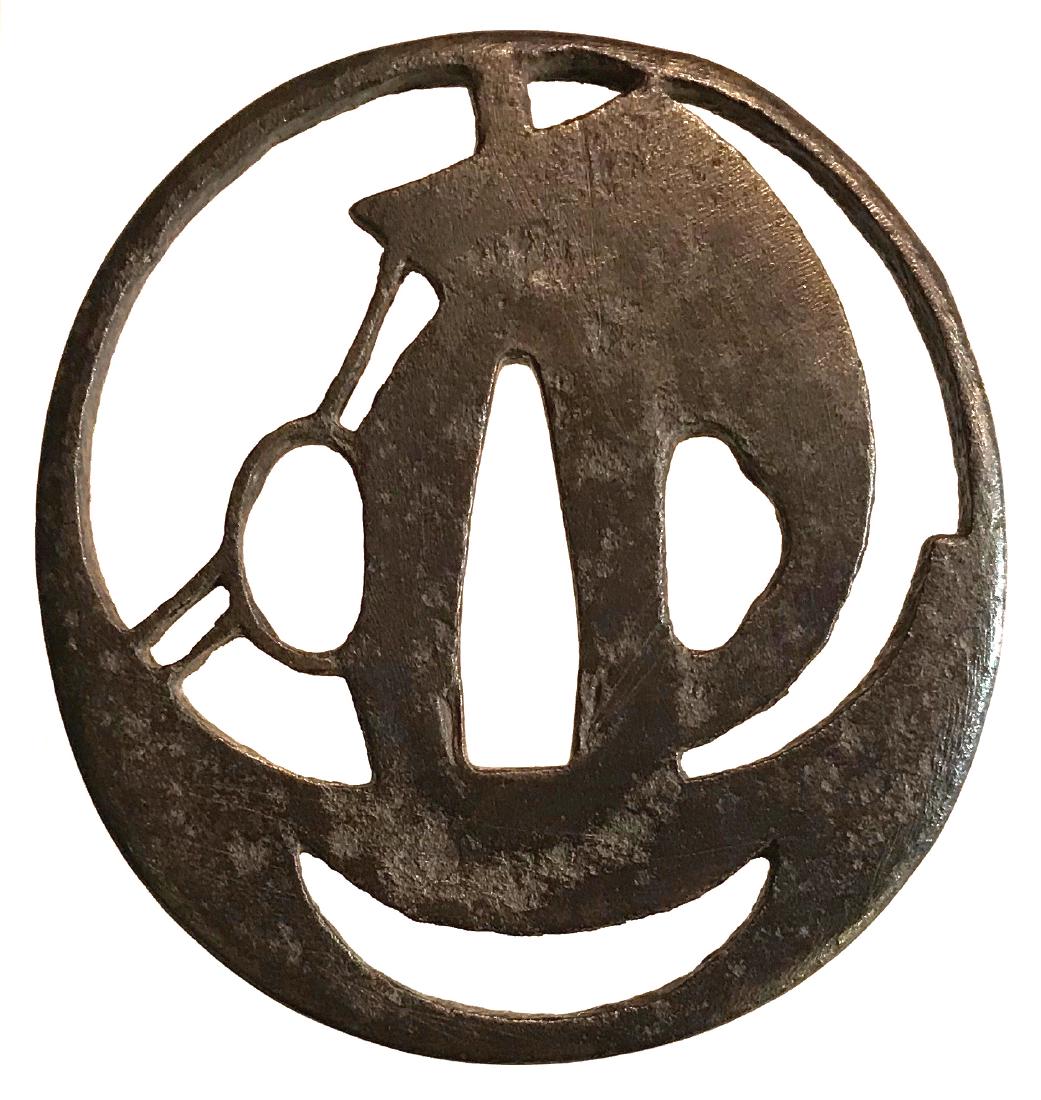 Iron sukashi tsuba with a bail boat motif: Item: Iron sukashi tsuba with a bail boat motif Origin: Japan Date: Edo Materials: Iron Dimensions: 71.0 x 66.7 x 4.5 mm Iron tsuba of elongated round form pierced with the design of a sail boat. Plea