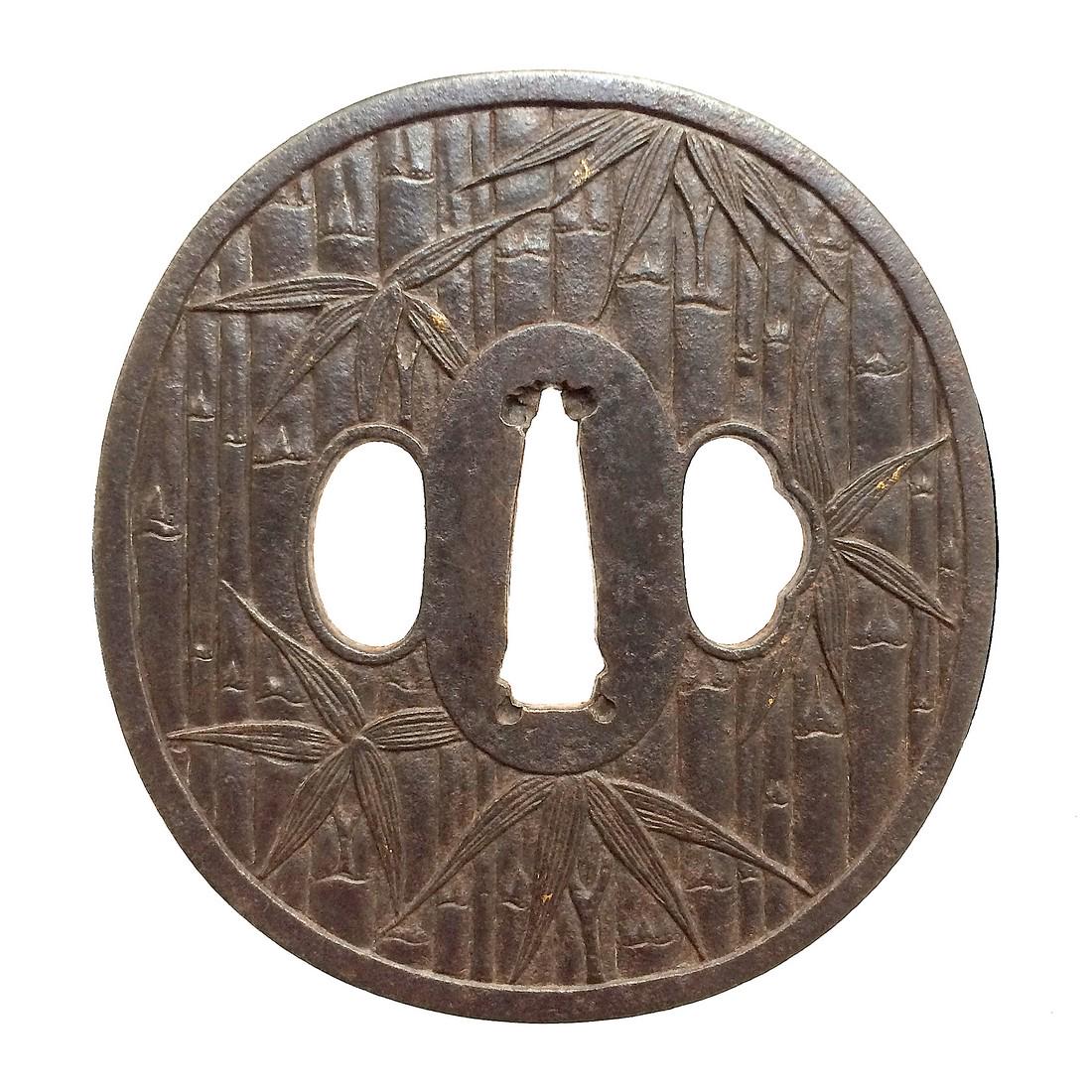 Iron tsuba carved with a bamboo motif: Item: Iron tsuba carved with a bamboo motif Origin: Japan Date: Edo period Materials: Iron Dimensions: Height: 81.9 mm; Width: 77.4 mm; Thickness: 4.3 mm; Weight: 149 g Iron tsuba of elongated round f