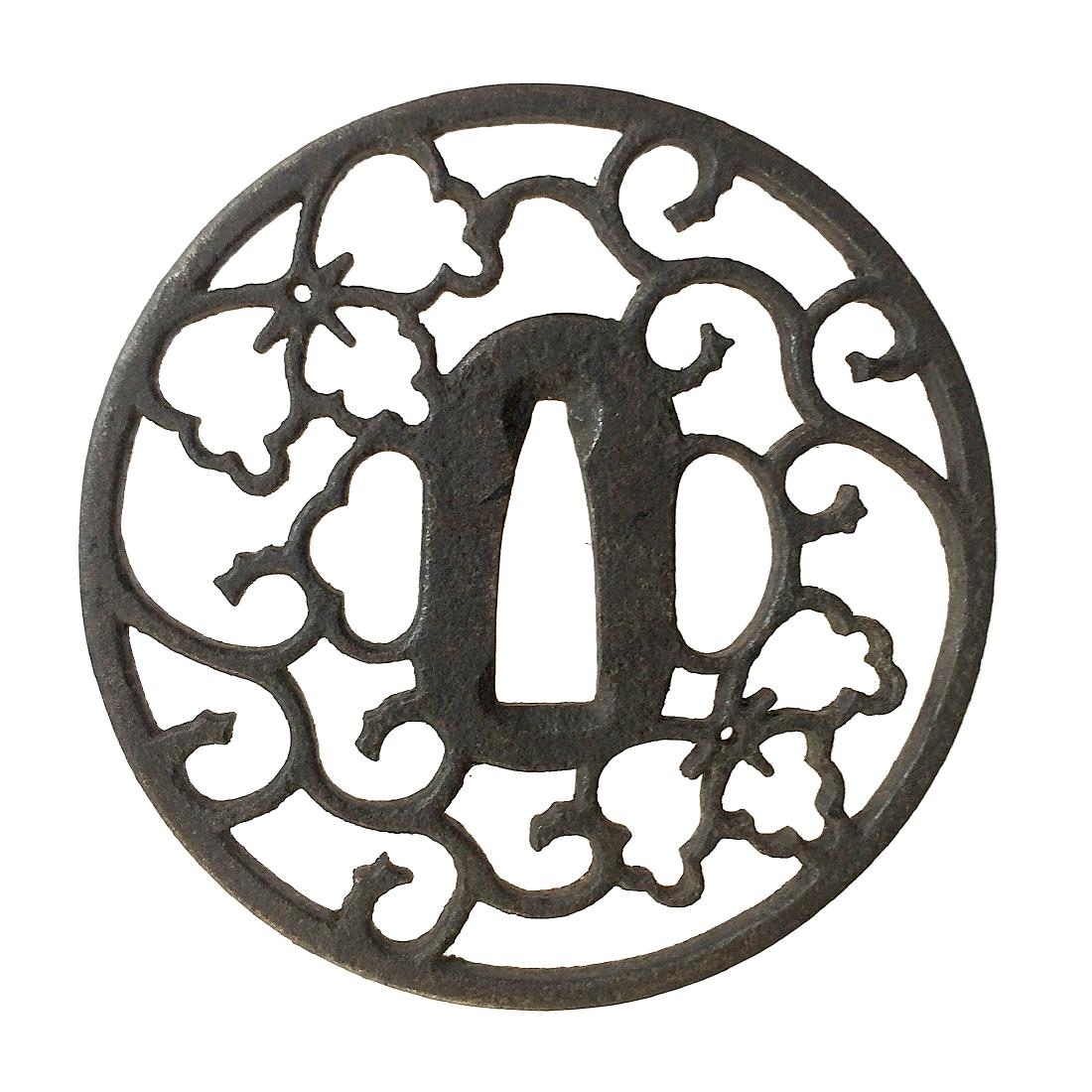 Iron sukashi tsuba with arabesque (karakusa) design.: Item: Iron sukashi tsuba with arabesque (karakusa) design. Origin: Japan Date: Edo period Materials: Iron Dimensions: 82.0 x 81.2 x 4.5 mm Iron tsuba of round form with the arabesque (karakusa) design