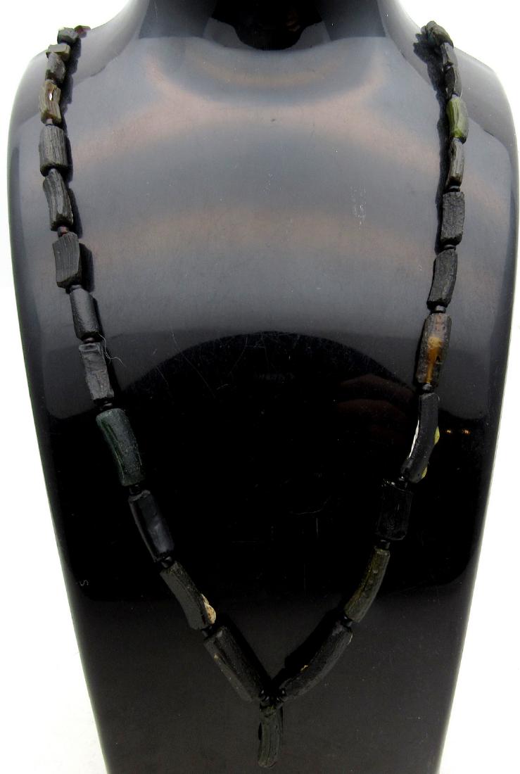 Roman Black Glass Necklace: Roman Black Glass Necklace Date: 1st - 3rd AD Description: Superb Ancient item in Wearable Condition, it comes with a lifetime guarantee of authenticity Roman Black Glass Necklace Material: glass Prov