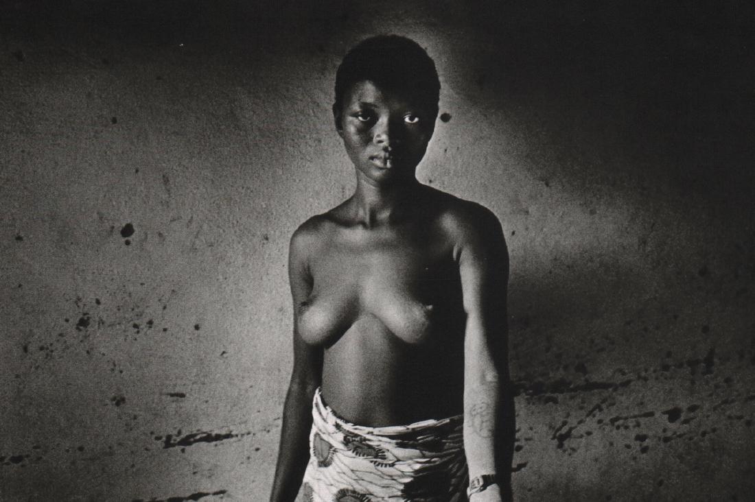 KARL KUGEL - Friendly Waitress: Artist: KARL KUGEL Print Title: Friendly Waitress in a neighborhood cafe in Ouagadougou, Burkina-Faso Medium: Sheet-fed Gravure Printing Date: 1987 Printed in France Image Size: 7.5 x 5 inches Karl Ku