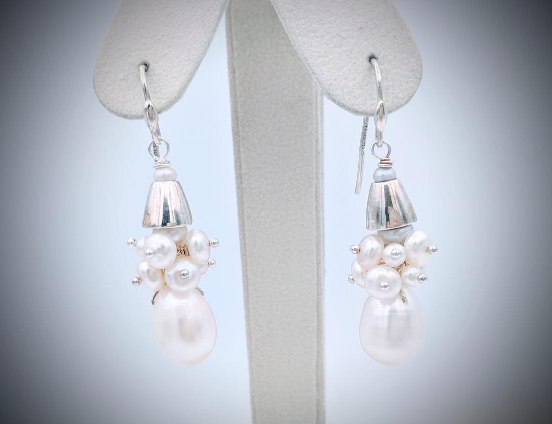 Sterling Silver Clustered Pearl Earrings: Item: Sterling Silver Clustered Pearl Earrings Brand: Jean Lin Collection Metal Purity: 925 Sterling Silver Gemstones: Pearls Carat Weights: 1 Pearl at 13.5×10mm, 6 Pearl's at 5.5, and 4 Pearl's at 3