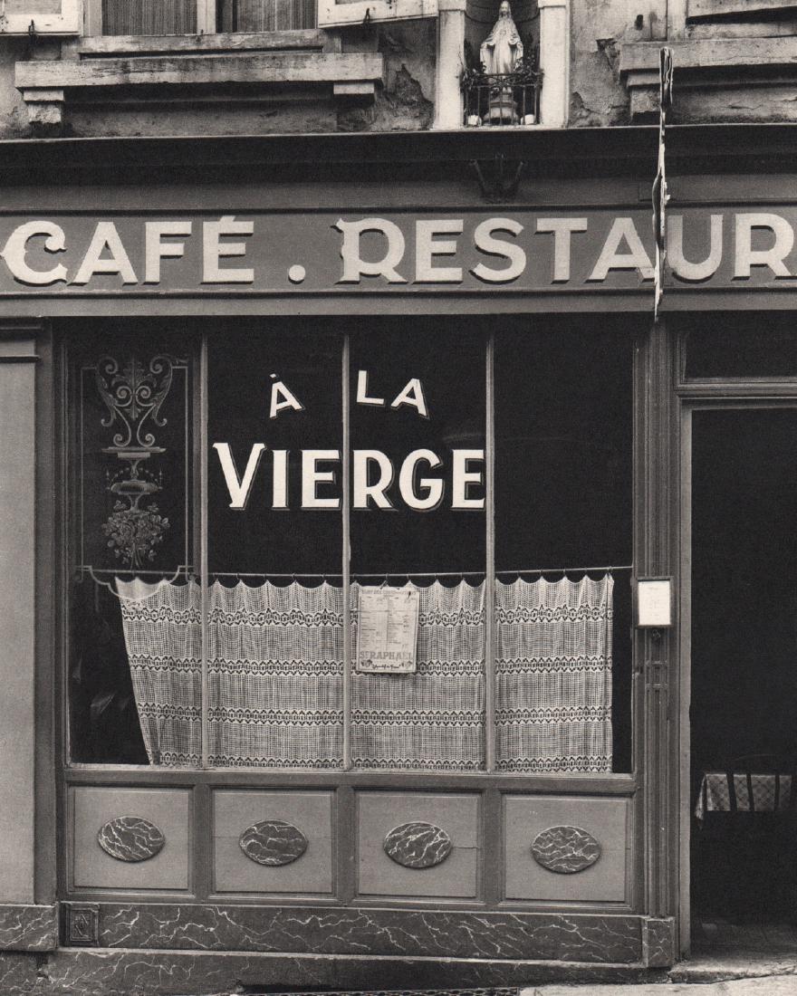 PAUL STRAND - Café A La Vierge: Artist: PAUL STRAND Print Title: Café A La Vierge Medium: Sheet-Fed Gravure Printing Date: 1952 Printed in Switzerland Image Size: 7.5 X 9.5 inches Paul Strand (1890–1976) was an American photograp