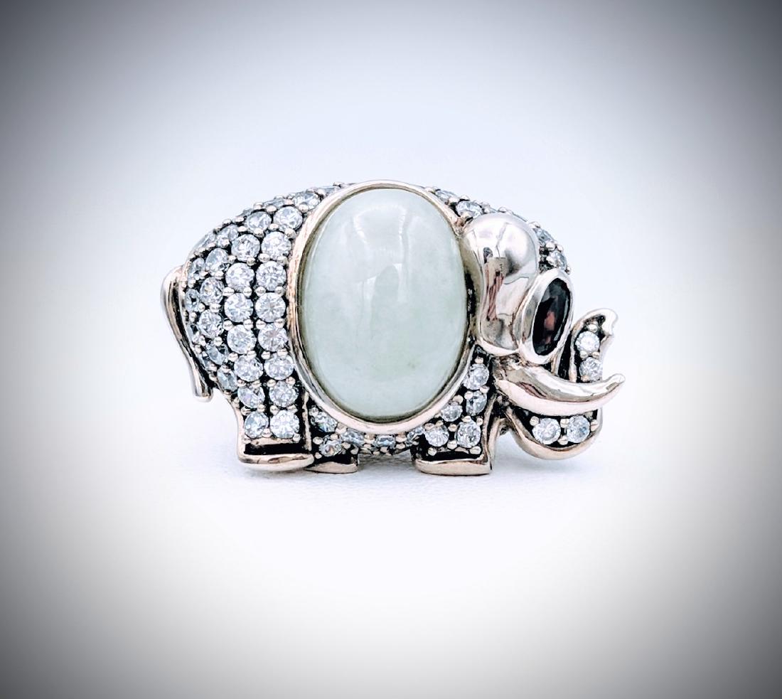 Sterling Silver Jade Garnet CZ Elephant Ring: Title: Sterling Silver Elephant Designed Ring with Jade, Almandine Garnet, and Cubic Zirconia Metal Purity: 925 Sterling Silver Gemstones: Jade, Almandine Garnet, and Cubic Zirconia Carat Weights: 1 O