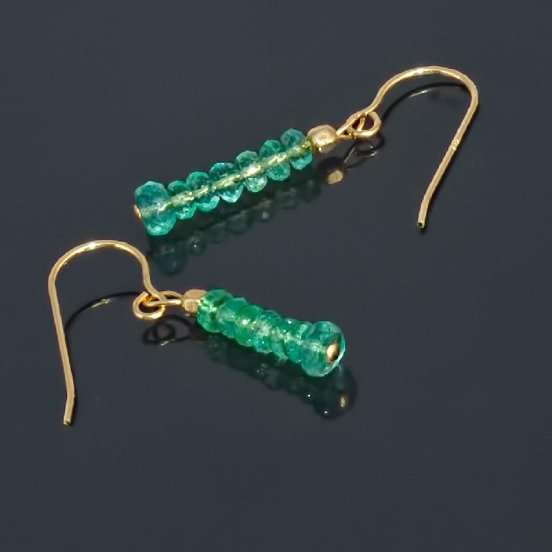 14K Earrings with Colombian Emeralds: Title: 14K Earrings with Colombian Emeralds Metal Purity: .585 Yellow Gold Gemstones: Colombian Emerald Size: External length (inc. fittings) ~ 1" (2.4 cm) Emerald faceted rondelle-shaped ~ 2.2-3 mm �
