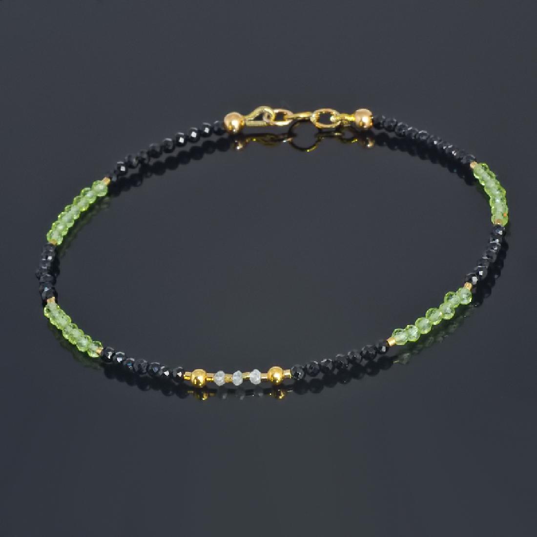 Spinel and Peridot bracelet with Diamonds 0.2 carat: Title: Spinel and Peridot bracelet with Diamonds 0.2 carat total weight Metal Purity: .585 Yellow Gold Gemstones: Spinel, Peridot, Diamond Size: External length (inc. clasp) ~ 7.5" (19 cm) Spinel face