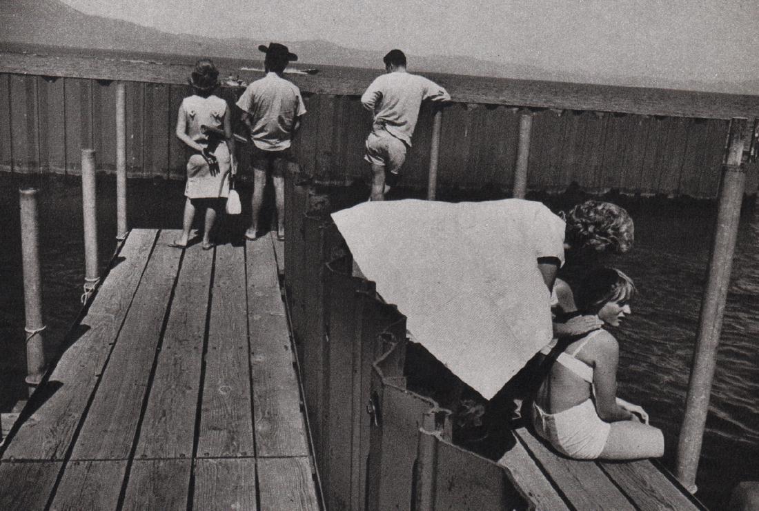 GARRY WINOGRAND - On the Dock: Artist: GARRY WINOGRAND Print Title: On the Dock Medium: Sheet-fed Gravure Printing Date: 1972 Printed in England Image Size: 7.25 x 4.75 inches Garry Winogrand (1928-1984) was a street photographer f