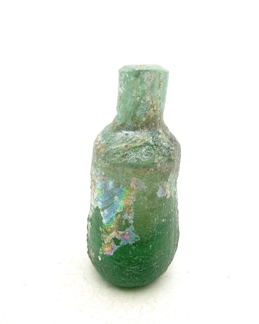 Ancient Roman Glass Flask -re: Title: Ancient Roman Glass Flask -re Date: C.100 - 300 A.D. Interesting Ancient Roman Glass Flask with beautiful irridescence in original, ancient unrestored condition. Charming small item suitable fo