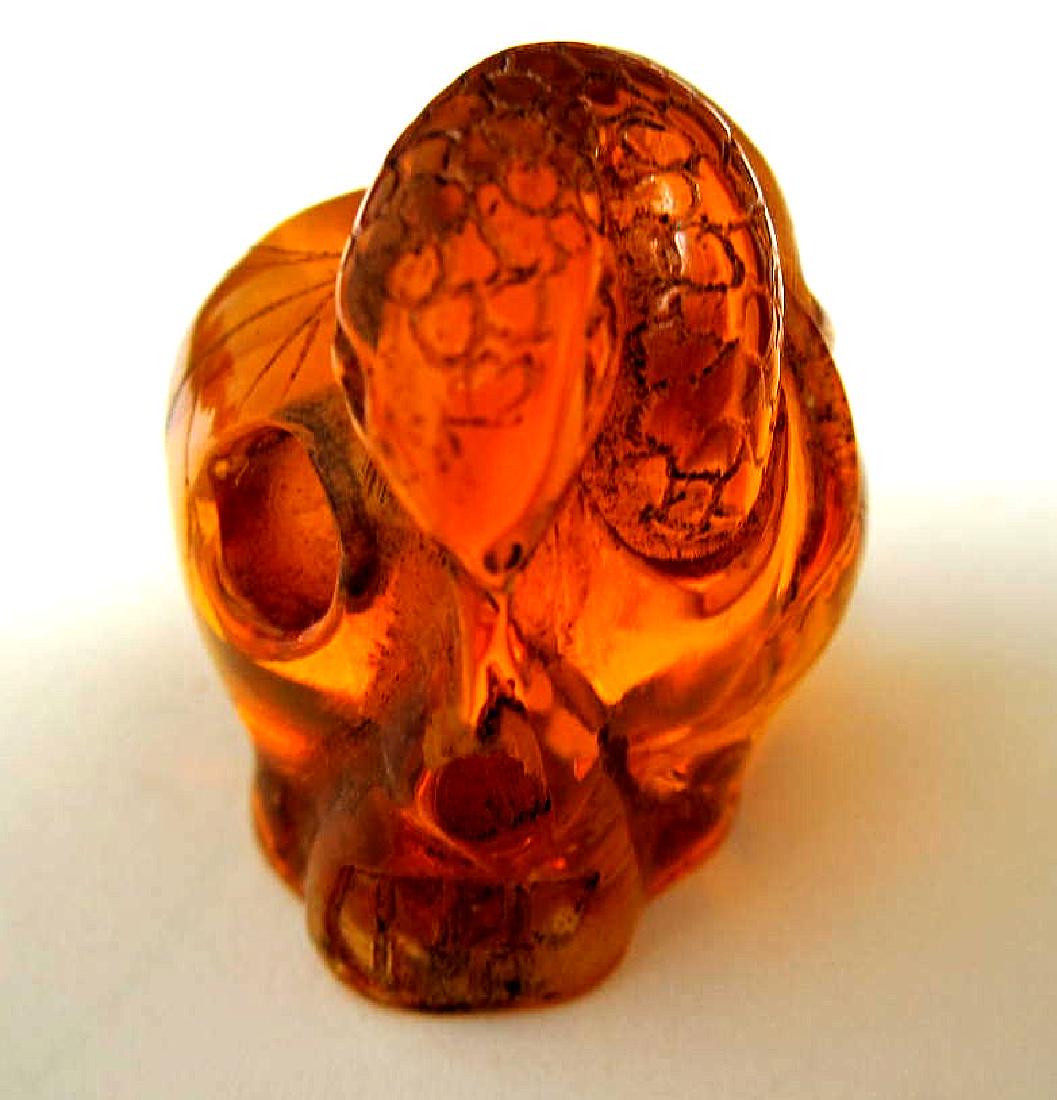 Japanese amber netsuke - Mouse and Snake on: Title: Japanese amber netsuke - Mouse and Snake on Skull,signed Date: 1940s Materials: reconstituted amber Size: 1 by 1 1/2 inches signed by artist Shipping: Domestic: Flat-rate of $6.95 to anywhere w
