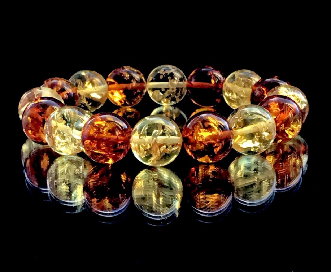 Bracelet Baltic amber cognac&lemon ø13mm 17.9 grams: Item: Bracelet Baltic amber cognac&lemon ø13mm 17.9 grams Gemstones: Baltic amber Weight: 17.9 grams Size/Dimensions: ø13mm Additional Information: colour: cognac and lemon Please note that this lot