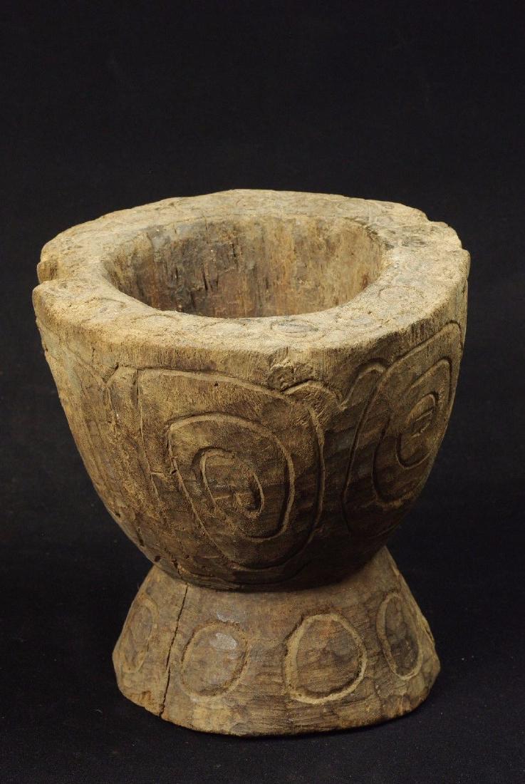 Old Weathered Wooden Corn Pounder Vase Atoni Indonesia: On offer is a rare old and authentic piece, a massive heavy wood vase use to break corn and make flour. It is carved with simple traditional motifs both on the sides and the top, where the original en
