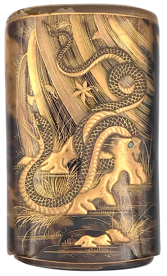 Japanese cigar case: Item: Japanese cigar case Origin: Japan Date: Edo/Meiji Materials: Celluloid Dimensions: 127 x 74 x 27 mm Celluloid cigar case decorated with gold depicting an eagle on one side and a serpent on the o