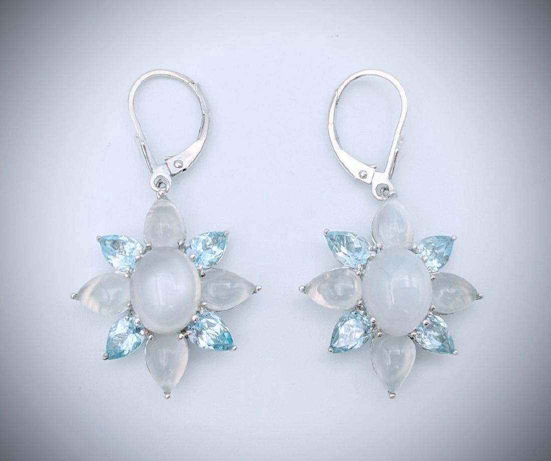 Sterling Silver Cats Eye Moonstone Blue Topaz Earrings: Item: Sterling Silver White Cats Eye Moonstone, and Blue Topaz Brand: Jean Lin Collection Metal Purity: 925 Sterling Silver Gemstones: White Cats Eye Moonstone and Blue Topaz Each Earring has 1 Oval W