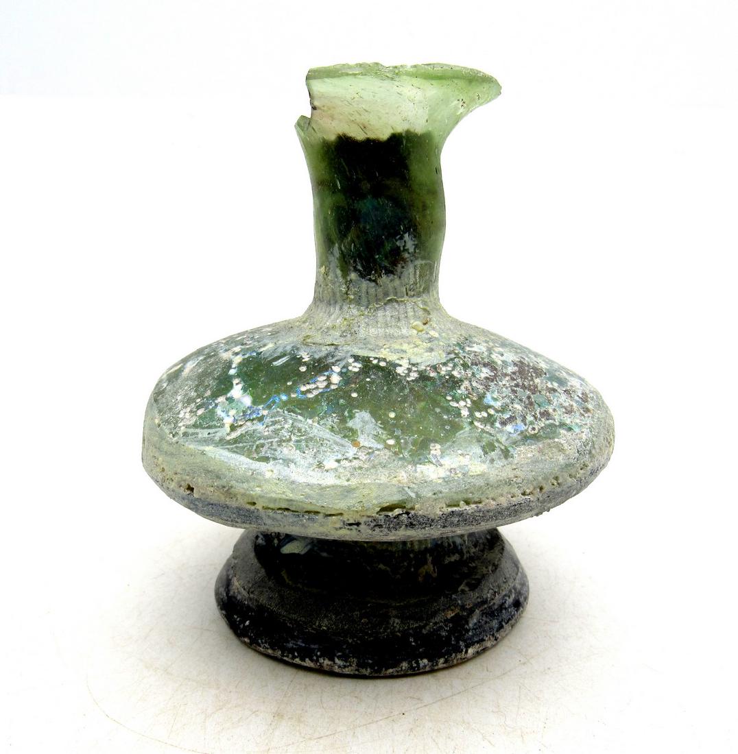Ancient Roman Glass Flask -re: Item: Ancient Roman Glass Flask -re Date: ca. 100 - 300 AD Whilst the ancient Egyptians and Phoenicians developed coloured glass, mainly for inlays, beads, etc., it was the Romans who perfected the de