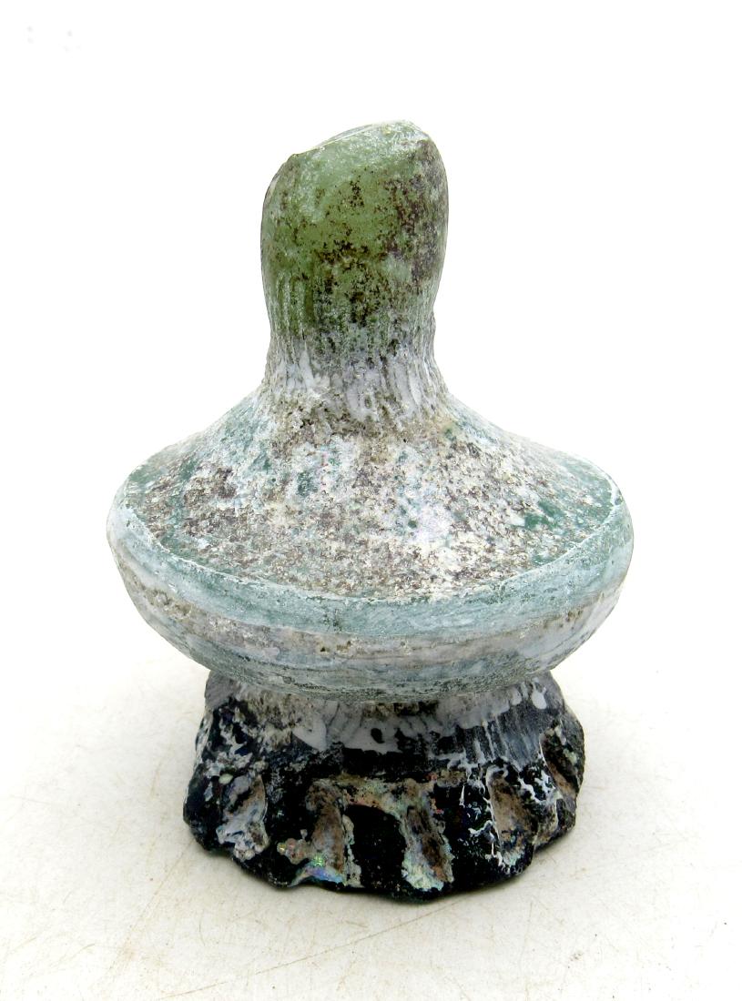 Ancient Roman Glass Flask -re: Item: Ancient Roman Glass Flask -re Date: ca. 100 - 300 AD Whilst the ancient Egyptians and Phoenicians developed coloured glass, mainly for inlays, beads, etc., it was the Romans who perfected the de