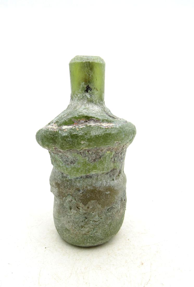 Ancient Roman Glass Flask -re: Item: Ancient Roman Glass Flask -re Date: ca. 100 - 300 AD Whilst the ancient Egyptians and Phoenicians developed coloured glass, mainly for inlays, beads, etc., it was the Romans who perfected the de